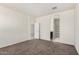 A view of this bedroom featuring neutral walls, brown carpeting, and a doorway leading to the bathroom at 5240 E Gummite Dr, San Tan Valley, AZ 85143