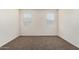 This bedroom features neutral walls, brown carpeting, and two windows with white blinds at 5240 E Gummite Dr, San Tan Valley, AZ 85143