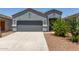 Charming single-story home featuring a well-manicured front yard and two-car garage at 5240 E Gummite Dr, San Tan Valley, AZ 85143