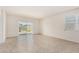 Bright and airy living room with tile flooring and sliding glass door access to the backyard at 5240 E Gummite Dr, San Tan Valley, AZ 85143