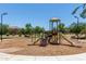 Community playground with slides, climbing features, and benches under a sunny sky at 5240 E Gummite Dr, San Tan Valley, AZ 85143