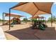 Community playground featuring slides, climbing structures, and sunshade for outdoor fun at 5240 E Gummite Dr, San Tan Valley, AZ 85143