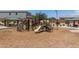 Community playground with climbing wall, slides, picnic tables, and shade canopies at 5240 E Gummite Dr, San Tan Valley, AZ 85143