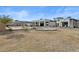 Expansive backyard showcasing the home's exterior, pool, lounge area, and drought-tolerant landscaping at 5827 S Marin Ct, Gilbert, AZ 85298