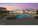 A serene backyard featuring a large private pool and outdoor lounging area at 5827 S Marin Ct, Gilbert, AZ 85298