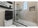 Stylish bathroom featuring a shower with a glass door and an accent wall with modern shelving at 5827 S Marin Ct, Gilbert, AZ 85298
