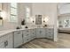 Bathroom with a double sink vanity, decorative mirror, and shutters on the windows at 5827 S Marin Ct, Gilbert, AZ 85298
