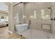 Elegant bathroom boasting a glass shower, soaking tub, and stylish tile work at 5827 S Marin Ct, Gilbert, AZ 85298