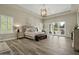 Spacious main bedroom with wood floors, tray ceiling, and a private entrance to backyard at 5827 S Marin Ct, Gilbert, AZ 85298