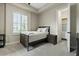 Serene bedroom with a comfortable bed, side table, window shutters, and a closet, creating a cozy atmosphere at 5827 S Marin Ct, Gilbert, AZ 85298