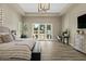 Bedroom featuring a tray ceiling, wood floors, and a backyard view through sliding glass doors at 5827 S Marin Ct, Gilbert, AZ 85298