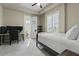This bedroom features a ceiling fan, plantation shutters, and an attached bathroom at 5827 S Marin Ct, Gilbert, AZ 85298