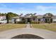 Charming home with manicured landscaping, circular driveway, and inviting entryway at 5827 S Marin Ct, Gilbert, AZ 85298