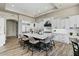 Spacious kitchen featuring a large center island with seating and white cabinets with black hardware at 5827 S Marin Ct, Gilbert, AZ 85298