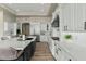 Well-appointed kitchen with white cabinets, stainless steel appliances, and a large center island at 5827 S Marin Ct, Gilbert, AZ 85298