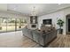 Spacious living room featuring a cozy fireplace, large windows, and a comfortable sectional sofa at 5827 S Marin Ct, Gilbert, AZ 85298
