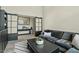 Comfortable living room with a gray sectional, coffee table and sliding doors with a decorative mirror at 5827 S Marin Ct, Gilbert, AZ 85298
