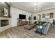 Bright living room with a corner fireplace, mounted television, and views of the backyard at 5827 S Marin Ct, Gilbert, AZ 85298