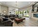 Spacious living room with modern finishes, large windows, and an open layout into the kitchen and pool at 5827 S Marin Ct, Gilbert, AZ 85298