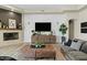 Elegant living room with a fireplace, stylish decor, and a comfortable seating arrangement at 5827 S Marin Ct, Gilbert, AZ 85298