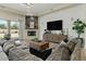Cozy living room with modern lighting, a fireplace, and a comfortable sectional sofa for relaxing at 5827 S Marin Ct, Gilbert, AZ 85298