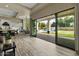 Open-concept living area with kitchen, dining, and backyard pool views through large sliding doors at 5827 S Marin Ct, Gilbert, AZ 85298