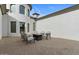 Covered outdoor patio with beautiful stone flooring and comfortable chairs for enjoying the outdoor living space at 5827 S Marin Ct, Gilbert, AZ 85298