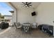Covered patio features a ceiling fan, a TV, and comfortable seating for outdoor dining and relaxation at 5827 S Marin Ct, Gilbert, AZ 85298