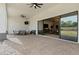 Spacious outdoor patio with brick flooring, ceiling fans, and large sliding glass doors to the home's interior at 5827 S Marin Ct, Gilbert, AZ 85298