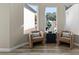 Cozy sitting area with armchairs, side table, and natural light from windows at 5827 S Marin Ct, Gilbert, AZ 85298