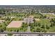 An aerial view shows the neighborhood park, baseball fields, parking and green space in an established community at 6231 E Desert Cove Ave, Scottsdale, AZ 85254