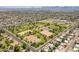 Expansive aerial view of neighborhood with parks, tree-lined streets, mountain backdrop, and community amenities at 6231 E Desert Cove Ave, Scottsdale, AZ 85254