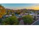 Sunset aerial view of property with mature trees and mountain backdrop at 6231 E Desert Cove Ave, Scottsdale, AZ 85254