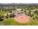 Aerial view showcases park with baseball fields, parking, playgrounds and green space in community at 6231 E Desert Cove Ave, Scottsdale, AZ 85254