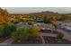 Aerial view of property with manicured landscaping and a mountain backdrop at sunset at 6231 E Desert Cove Ave, Scottsdale, AZ 85254