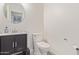 Powder room featuring a modern sink and vanity with tile accents and neutral paint at 6231 E Desert Cove Ave, Scottsdale, AZ 85254