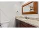 Bathroom featuring granite counters, a modern vanity and a decorative framed mirror at 6231 E Desert Cove Ave, Scottsdale, AZ 85254