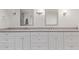 Dual vanity bathroom featuring stone counters and modern fixtures at 6231 E Desert Cove Ave, Scottsdale, AZ 85254