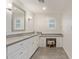 Bathroom featuring long vanity with stone counters, lots of cabinets and a makeup station at 6231 E Desert Cove Ave, Scottsdale, AZ 85254