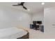 Bedroom boasts neutral colors, plush carpet, desk area, and a ceiling fan for comfort at 6231 E Desert Cove Ave, Scottsdale, AZ 85254