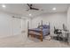 Sun-filled bedroom featuring soft carpet, modern ceiling fan and a sliding barn door at 6231 E Desert Cove Ave, Scottsdale, AZ 85254