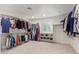 Walk-in closet featuring plentiful shelving and custom storage for optimal organization at 6231 E Desert Cove Ave, Scottsdale, AZ 85254