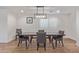 Dining area features modern chandelier lighting, hardwood floors, neutral paint, and shuttered windows at 6231 E Desert Cove Ave, Scottsdale, AZ 85254