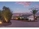 A single-story home showcasing a manicured front yard, brick accents, and a wide driveway at 6231 E Desert Cove Ave, Scottsdale, AZ 85254