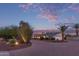 A single-story home showcasing a manicured front yard, brick accents, and a wide driveway at 6231 E Desert Cove Ave, Scottsdale, AZ 85254