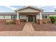 Inviting front entrance with brick columns, a covered porch, and a pathway leading to the front door at 6231 E Desert Cove Ave, Scottsdale, AZ 85254