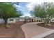 A single-story home showcasing a manicured front yard, brick accents, and a wide driveway at 6231 E Desert Cove Ave, Scottsdale, AZ 85254