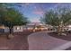 Charming single-story home featuring a well-manicured front yard and walkway under a picturesque sky at 6231 E Desert Cove Ave, Scottsdale, AZ 85254