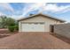 Exterior view of detached garage, featuring white doors, brick accents, and a paved driveway at 6231 E Desert Cove Ave, Scottsdale, AZ 85254