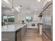 Bright kitchen with stainless steel appliances, a large island, shaker cabinets and a farmhouse sink at 6231 E Desert Cove Ave, Scottsdale, AZ 85254